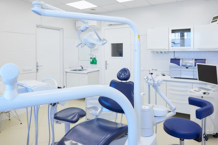A modern interior of a dental office with white and blue furniture, dental chair, wet milling, and grinding machine, intraoral scanner, a led polymerization light. Dentistâs office. Dental laboratory.の写真素材