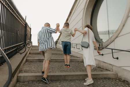 A family is climbing the stairs of the palace in an old European town.の写真素材