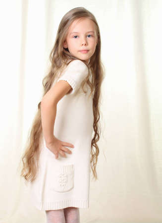 Portrait of little blond girl with hands on hipsの写真素材