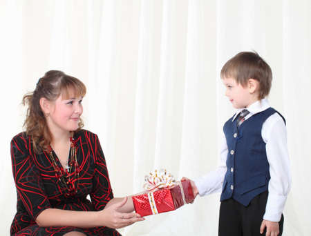 Little son gives present to his motherの写真素材