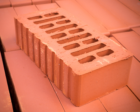 orange clay brick stack, pile. background. orange clay brick stack, pile. background.