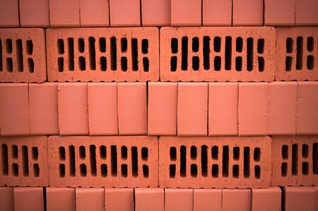 orange clay brick stack, pile. texture, background.の写真素材