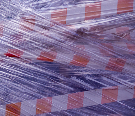 warning construction tape covered in plastic. background, industrial.の写真素材