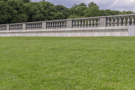 green grass with marble fence on the background. nature, architectureの写真素材