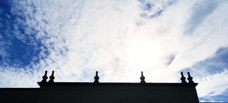 a particular formation of clouds make a beautiful contrast with the backlit silhouette of this beautiful colonial architecture buildingの写真素材