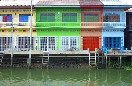 Multi color Thai style houses beside canal, samut songkhram, Thailandのeditorial素材