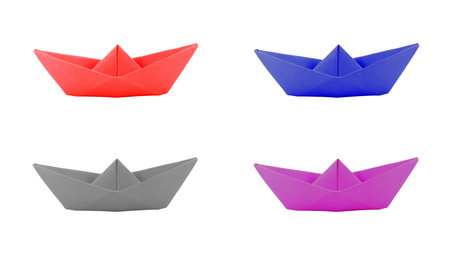origami four color paper boat on white background