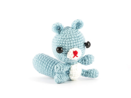 handmade crochet Raccoon doll on white backgroundの写真素材