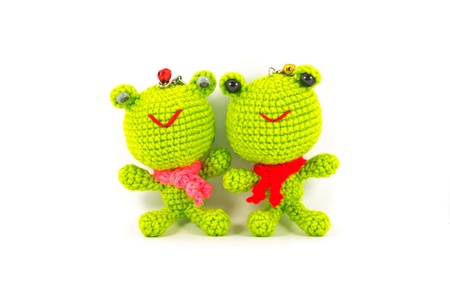 handmade crochet two green frog doll on white backgroundの写真素材