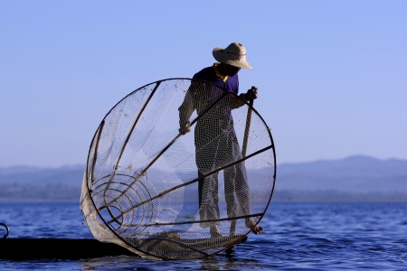 Fisherman of Inle Lake in action when fishing, Myanmarの写真素材