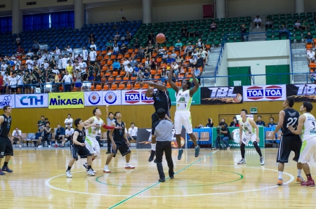 BANGKOK,THAILAND - 21 SEPTEMBER   both team player are jumping to get ball in Final Thailand Basketball League 2013 on Thai - Japanese Stadium between THEW Vs  HITECH on september 21, 2013 in bangkok,Thailandのeditorial素材