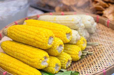 Steaming corn on traditional wood basketの写真素材
