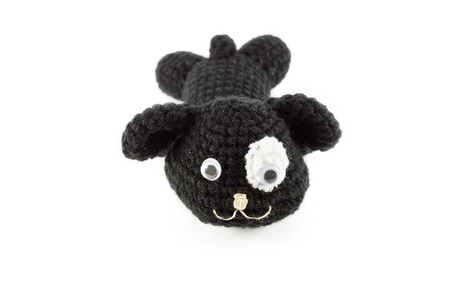 handmade crochet dog doll black color on white backgroundの写真素材