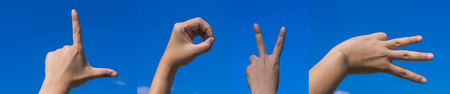 hands forming LOVE character for love with blue skyの写真素材