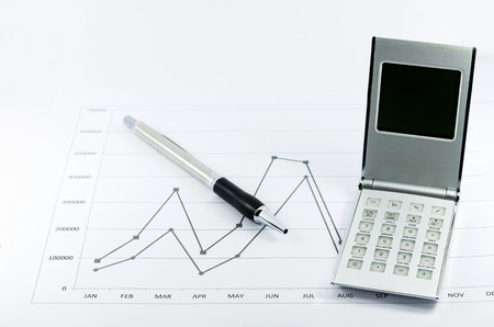 stock graph report with calculator and pen for businessの写真素材