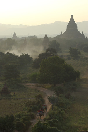 BAGAN - JAN 5 : Many pagoda of bagan with the horse carriage on the street for tourists at a big temple in The Bagan Archaeological Zone, Myanmar on Jan 5, 2011. Bagan is seen by many as equal in attraction to Angkor Wat in Cambodia.のeditorial素材
