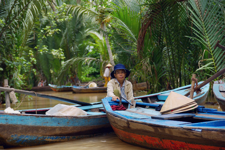 MYTHO, VIETNAM - JUN 21 : The Undefined fisherman sitting in the traditional wood boat at mekong Delta, mytho, vietnam on June 21, 2009.It is the first city in the Mekong Delta travellers from Ho Chi Minh Cityのeditorial素材