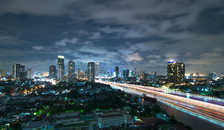 Bangkok cityscape Modern building river side at twilight time with boat traffic light,Thailandの写真素材