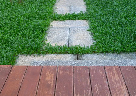 wood and granite Pathway on the grassの写真素材