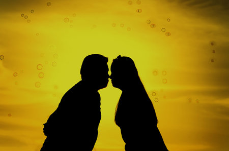 Romantic lovers with bubbles at sunset background, Silhouette concept