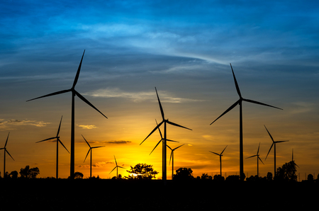 Wind turbine power generator with sunsetの写真素材