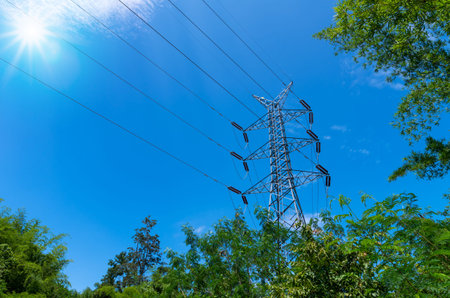 high voltage post and tower on blue sky background.