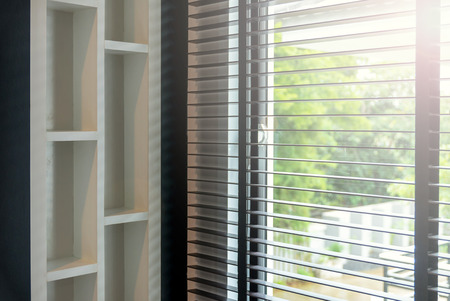 blinds inside a window being opened with bedroom interiorの写真素材