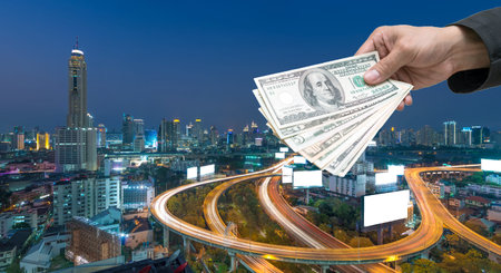 Businessman Hand with usd dollar money on Elevated highway