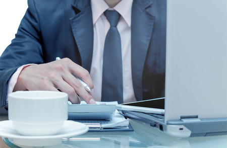 Businessman calculating the information with laptopの写真素材