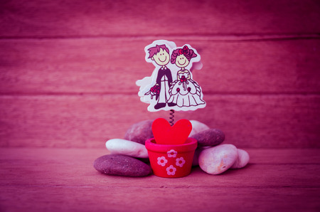 red heart in the pot with stone on the wood background, Valentine dayの写真素材