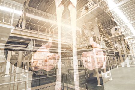 Double exposure of businessman with Industrial equipment Factoryの写真素材