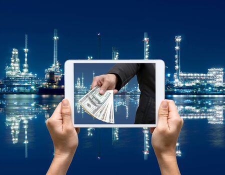 Female hands holding tablet taking pictures Petrochemical factoryの写真素材