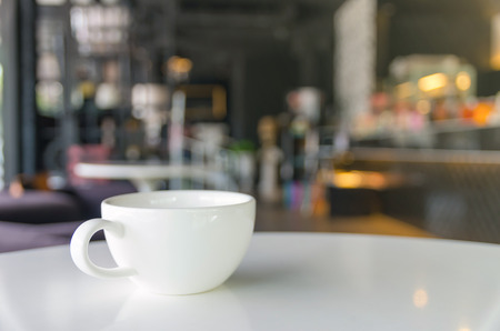 Coffee cup on coffee shop blur backgroundの写真素材
