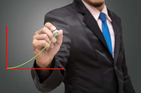 Businessman writing the upper graphの写真素材