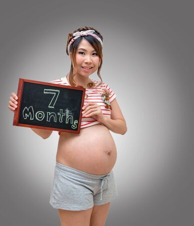 Pregnant woman with black boardの写真素材