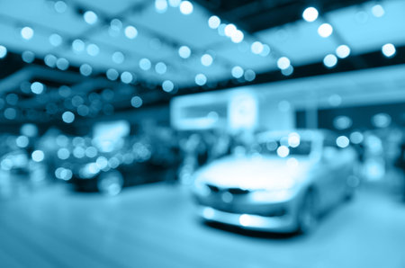 Abstract blurred photo of motor show, car show room, blur color toneの写真素材