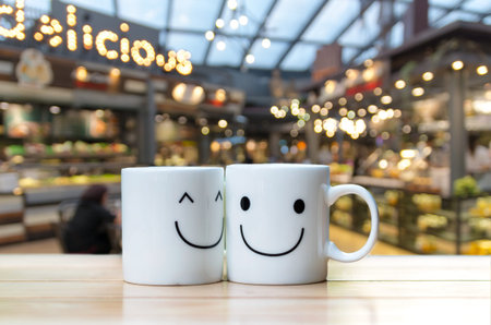 Two happy cups on coffee store blur backgroundの写真素材