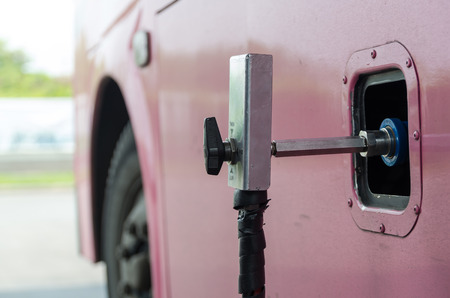 Gas nozzle to add gas in car at gas stationの写真素材