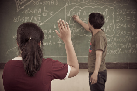 Raised hands in classroom at Schoolの写真素材