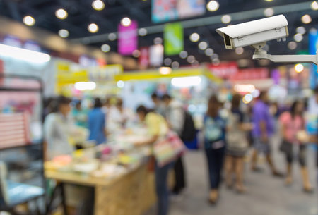 CCTV security camera on monitor the shopping center with people on Abstract blurred photo background