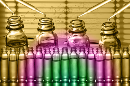 Chemical Laboratory,scientist dropping the reagent into test flaskの写真素材