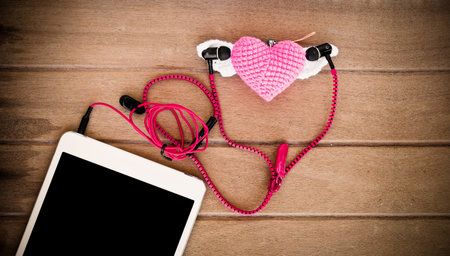 Portable audio earphones with tablets and heart Crochet on wood background, vintage color toneの写真素材