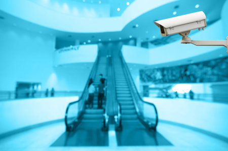 Security camera monitoring the Abstract blurred photo of escalator with bokeh background, blue color...