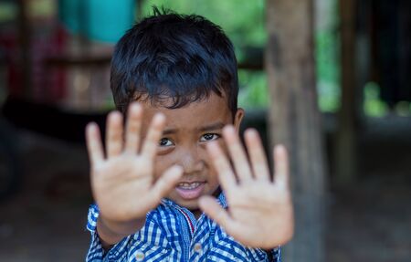 SIEM REAP, CAMBODIA - MAY 2 : Closeup face of Unidentified boy of Cambodian in not permit action at kabal spean on May 2, 2015 in Siem Reap, Cambodiaのeditorial素材
