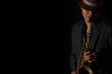 A saxophone player in a dark backgroundの写真素材
