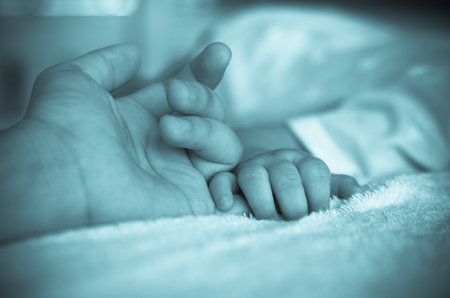 Asian baby hand on the adult hand