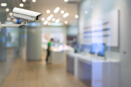 CCTV security camera on monitor the abstract store blurred in hall with bokeh backgroundの写真素材