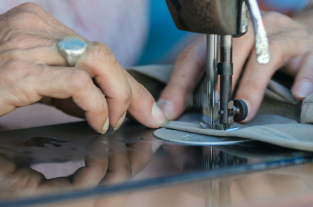 Sewing Process with old man designer hand, focus at fingerの写真素材