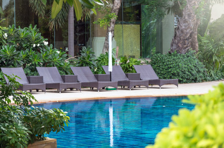 Luxury pool chairs beside the swimming poolのeditorial素材