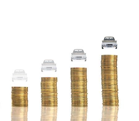 stacks of gold coins with car as a goal on white background, business investment conceptの写真素材